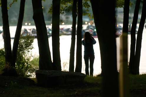 <p>
	A spectator stands amongst the trees of Oneida Shores Park to watch the take-off.</p>
