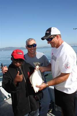 <p>
	Thumbs up from Arnez while Skeet Reese and Mark Fisher show how excited they are about his first fish.</p>
