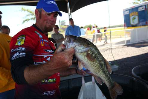 <p>
	Clark Reehm, formerly of Russellville, Ark., now of Lufkin, Texas, displays his best fish among four that weighed 8-4 and left him in 32nd place after Day One.</p>
