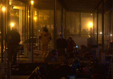 <p>
	Anglers mill around in the darkness at the Table Rock Lake State Park Marina as they await take-off on Day Two of the Bass Pro Shops Bassmaster Central Open #3.</p>
