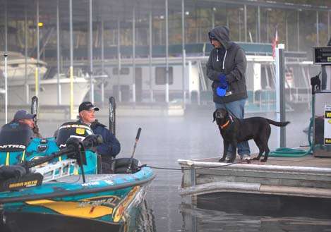 <p>
	Rick Clunn remains tethered to the dock as he passes time during the fog delay.</p>
