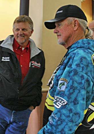 <p>
	Anglers like Branson's Robert Robbins (left) and Rick Clunn mingle as they await the tournament briefing.</p>
