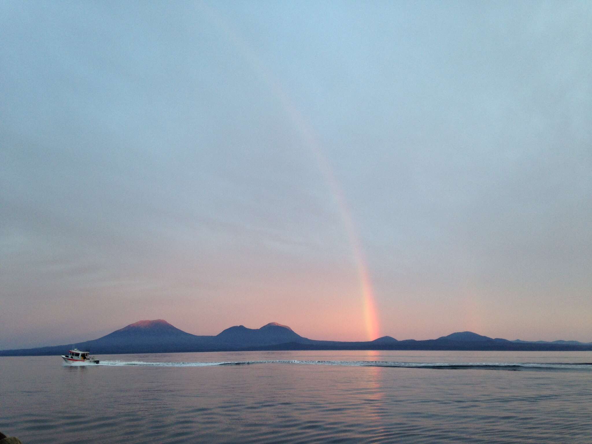 Morning rainbow over Mt. Edgecumbe (a dormant volcano located at the southern end of the Kruzof Island near Sitka, AK).