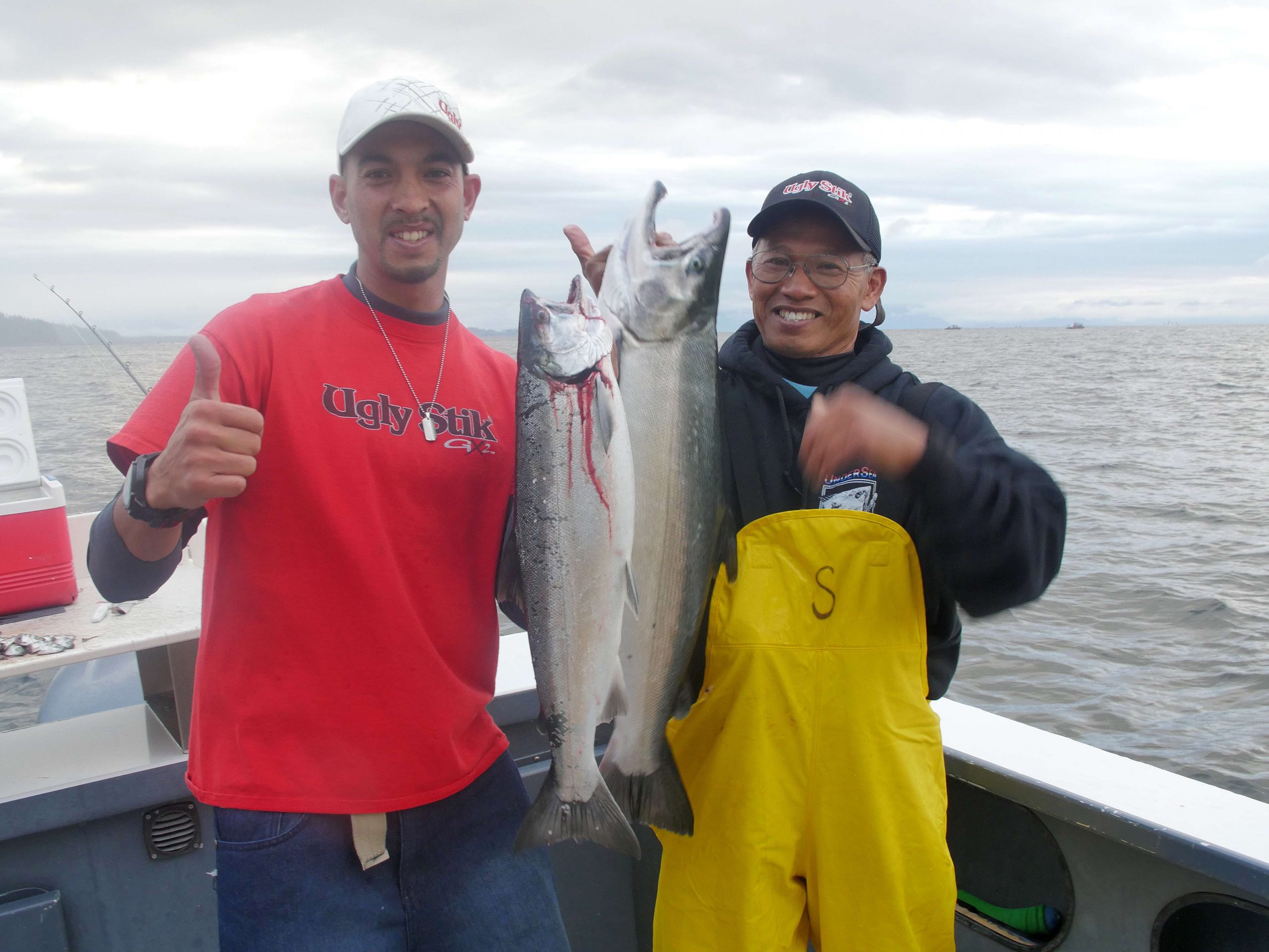 Chris Pascua and his dad Vito holding up their salmon on the way to limiting out for the day.