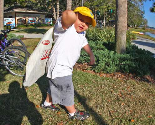 <p>
	 </p>
<p>
	A young fan struggles to carry a large bag of Florida bass down to the release boat.</p>
