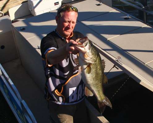<p>
	 </p>
<p>
	The release boat crew holds up one of the biggest bass caught on Day Two.</p>
