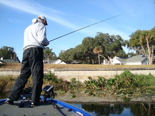 <p>
	Bobby Myers fishes in a canal while looking for beds.</p>
