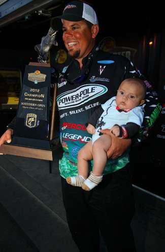 <p>
	 </p>
<p>
	Lane poses for a photo with the championâs trophy and his baby boy, Colman. </p>
