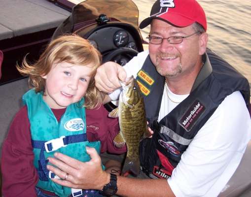 <p>
	Scott Carlisle poses with his daughter, Devon, after she catches her very first smallmouth!</p>
