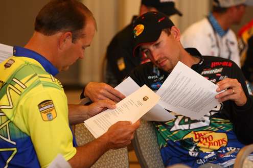 <p>
	Steve Kennedy and Ott Defoe check out the official rules sheet for the 2012 Bassmaster Classic.</p>
