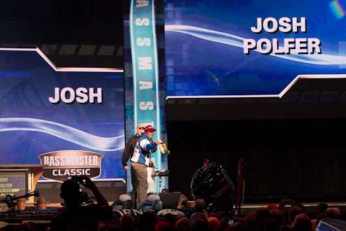 Josh Polfer pulls a big fish from the livewell on Day Two of the Bassmaster Classic.
