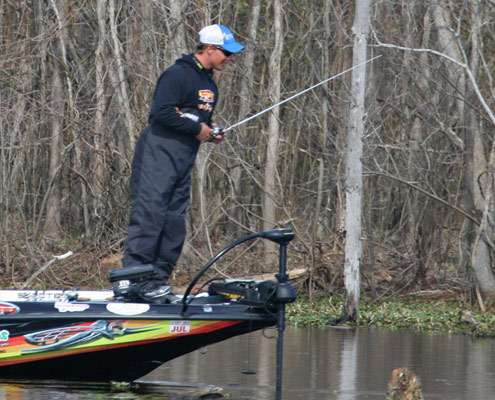 Keith Poche goes on point as he locates a sizable bass on a bed.
