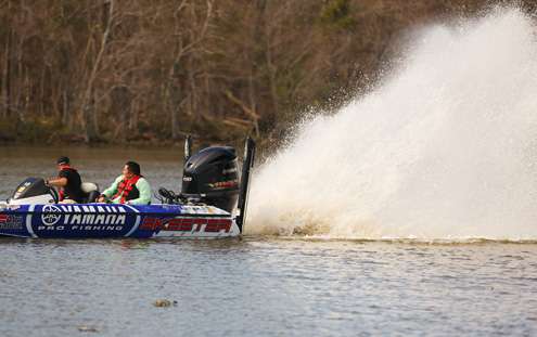Brandon Palaniuk sprays a rooster tail from the back of his boat after hanging on a stump. 
