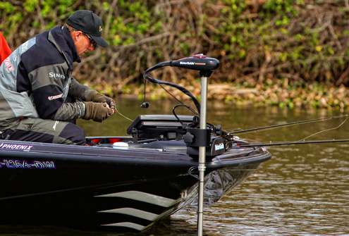<p>
	Aaron Martens takes a seat on the bow of his boat to make some bait changes. </p>
