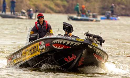 <p>
	Mike Iaconelli takes a perch on top of his boat seat to get a better view of the stumps he was navigating. </p>
