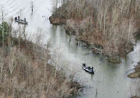 Anglers make their way into backwaters.<
