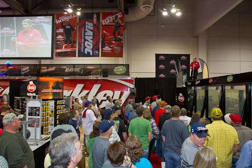 <p>
	Hank Parker gives a lure demonstration atop the tank at the Berkley booth.</p>
