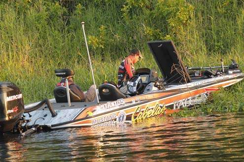 <p>
	While boats take off, Mike McClelland works on his tackle.</p>
