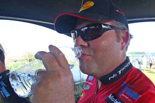 <p>
Brian Snowden hydrates after a hot afternoon on the St. Johns River.</p>