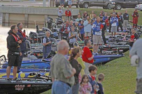 <p>
	Anglers line the bank for the playing of the national anthem.</p>
