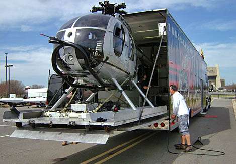 <p>
	Like something out of a James Bond film, the helicopter slides out of the trailer bay on a dolly.</p>
