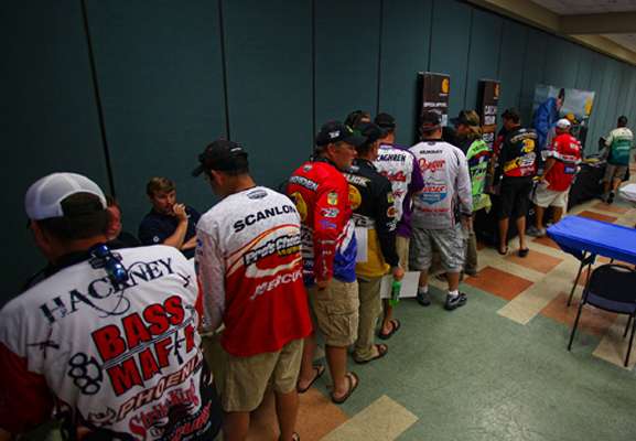 <p>
	Competitors line up to finish the registration process. </p>
