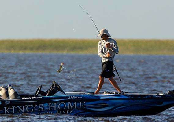 <p>
	Randy Howell swings a small keeper into the boat. </p>
