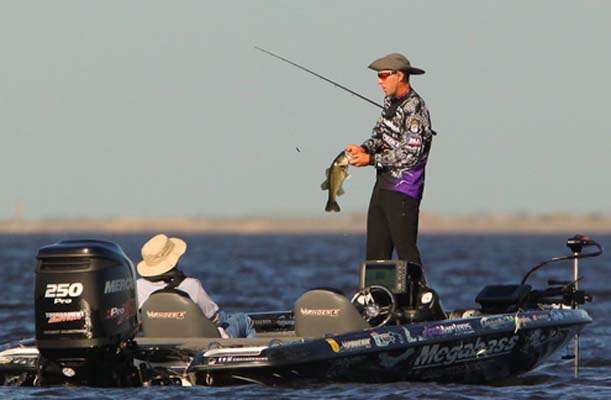 <p>
	Aaron Martens unbuttons a small keeper fish. </p>
