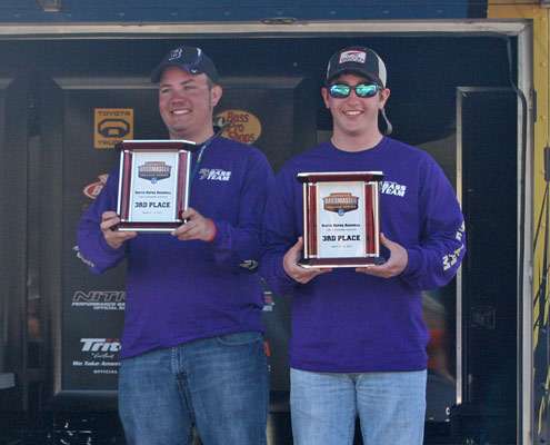 <p>
	Third-place anglers Dillon McGee and Tanner Ellis from Bethel University show off their hardware.</p>
