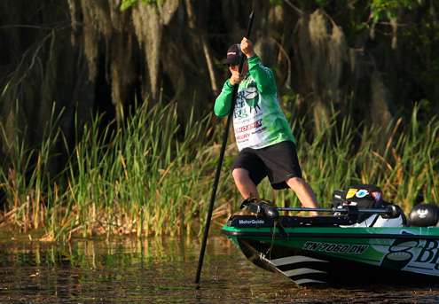 <p> 	Day One leader J Todd Tucker strains to move his boat about in shallow water with a push pole.</p> 