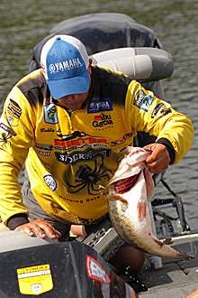 <p>
	Bobby Lane sacks up one of his lunkers on Day One.</p>
