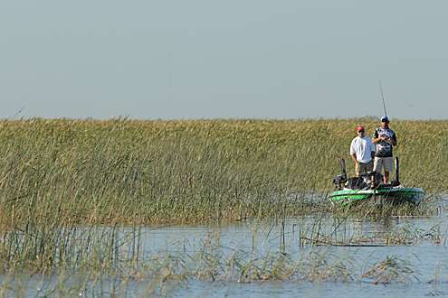 <p>
	On the second day of the 2012 Bassmaster Elite Series Power-Pole Slam, anglers are looking for big sacks to bring to the scales from Florida's Lake Okeechobee. Here, Clark Reehm scouts for solid largemouth in vegetation.</p>
