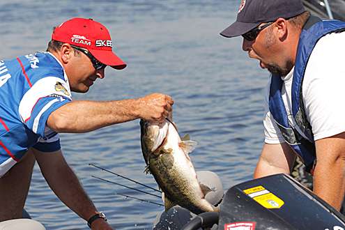 <p>
	Todd Faircloth puts one of his larger fish in his weigh-in bag Friday.</p>
