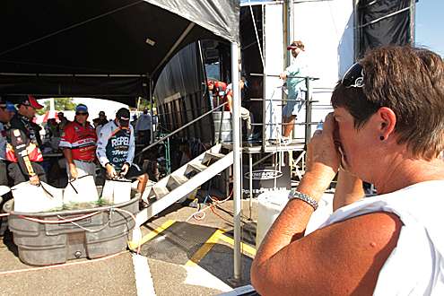 <p>
	A fan takes a photo of anglers waiting to weigh in.</p>
