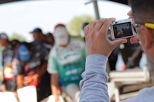 <p>
	A fan takes video of the anglers as they stand in line at the tanks backstage.</p>
