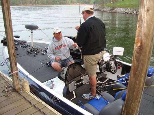 <p>
	Jeff Stoner (sitting) and Jarrod Nelson, two of my housemates, prepare tackle at the homeâs dock.</p>
