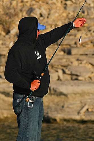 <p>
	Lane checks out his crankbait and line after getting hung on some rocks.</p>
