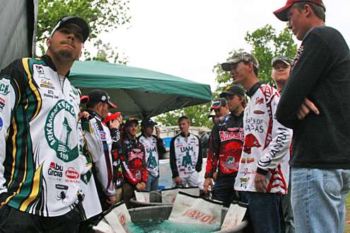 The college anglers wait at the tanks for weigh-in.