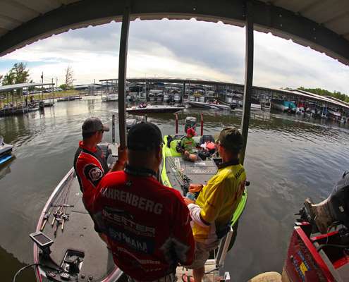 A group of anglers hang around talking to Brent Chapman.
