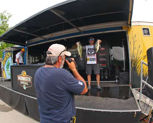 Brady Winans holds up his two biggest bass as James Overstreet shoots for Bassmaster.com.
