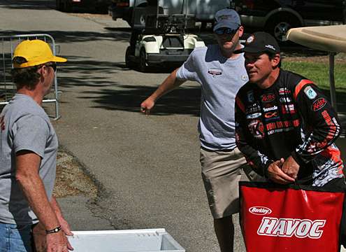 Grant Goldbeck hops out from one of the golf carts that shuttled anglers from the parking area to the stage for the Day One weigh-in of the TroKar Quest.

