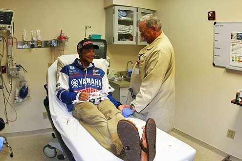 <p>
	Dr. Jackson applies pressure to the wound as the two talk fshing, including his catch of a 12.4-pounder on Lake Fork.</p>
