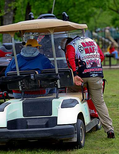 <p>
	Greg Hackney gets into a golf cart taking him from the parking area to the stage.</p>
