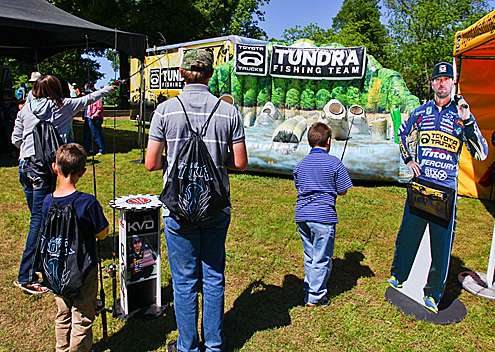 <p>
	Spectators try their hand at pitching to targets at the Toyota Tundra booth.</p>
