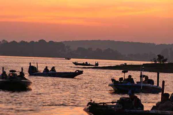 <p>
	The sun begins to rise as anglers prepare to start the day.</p>
