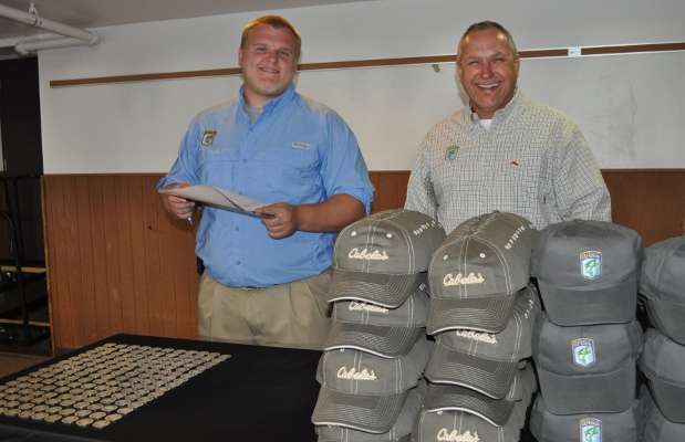 <p>
	B.A.S.S. staffers Brett Stewart and Tony Quick prepare to hand out hats and specially made coins to contenders.</p>
