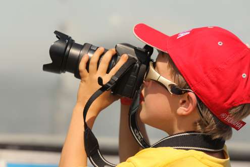 <p>
	A young photography enthusiast checks out the festivities through a viewfinder.</p>
