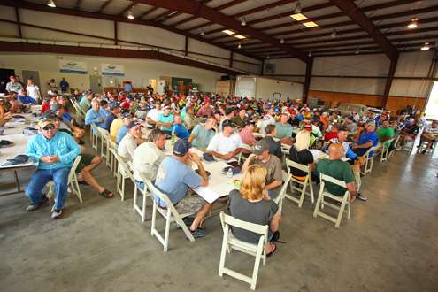 <p>
	Marshals and pros meet to await their pairings.</p>
