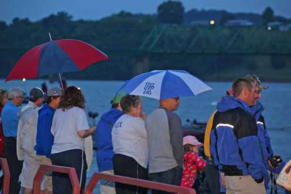 
<p>
	Fans lined the dock with umbrellas as rains continued and storms brewed.</p>
