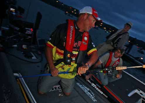 <p>
	Jeff Kriet pulls his rods from his boat and lays them on the deck.</p>
